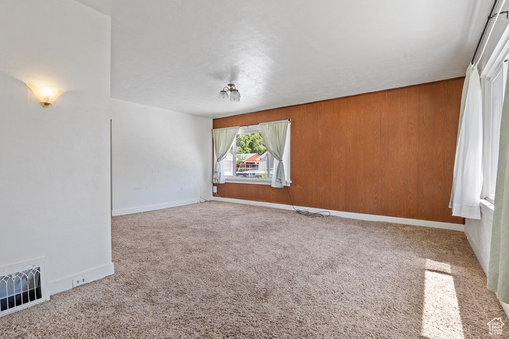 Empty room with carpet and baseboards