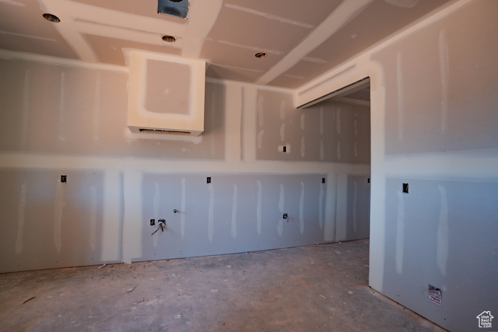 Spare room featuring unfinished concrete flooring