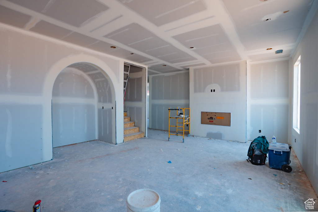 Unfurnished living room featuring stairs
