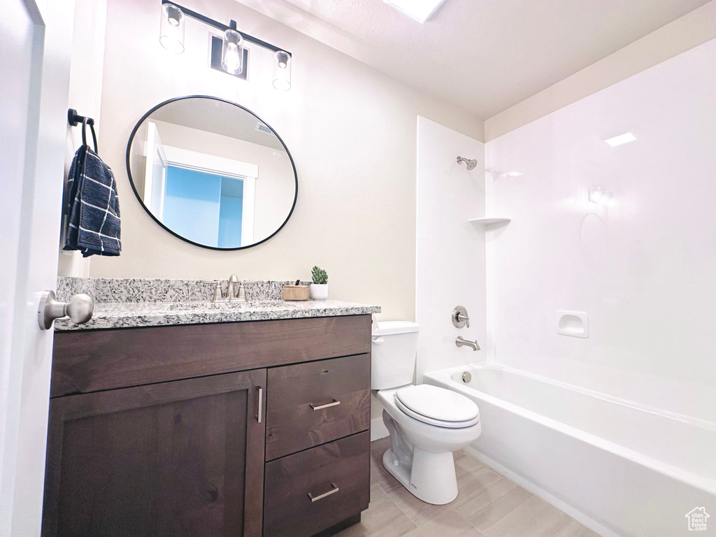Bathroom with vanity and bathing tub / shower combination
