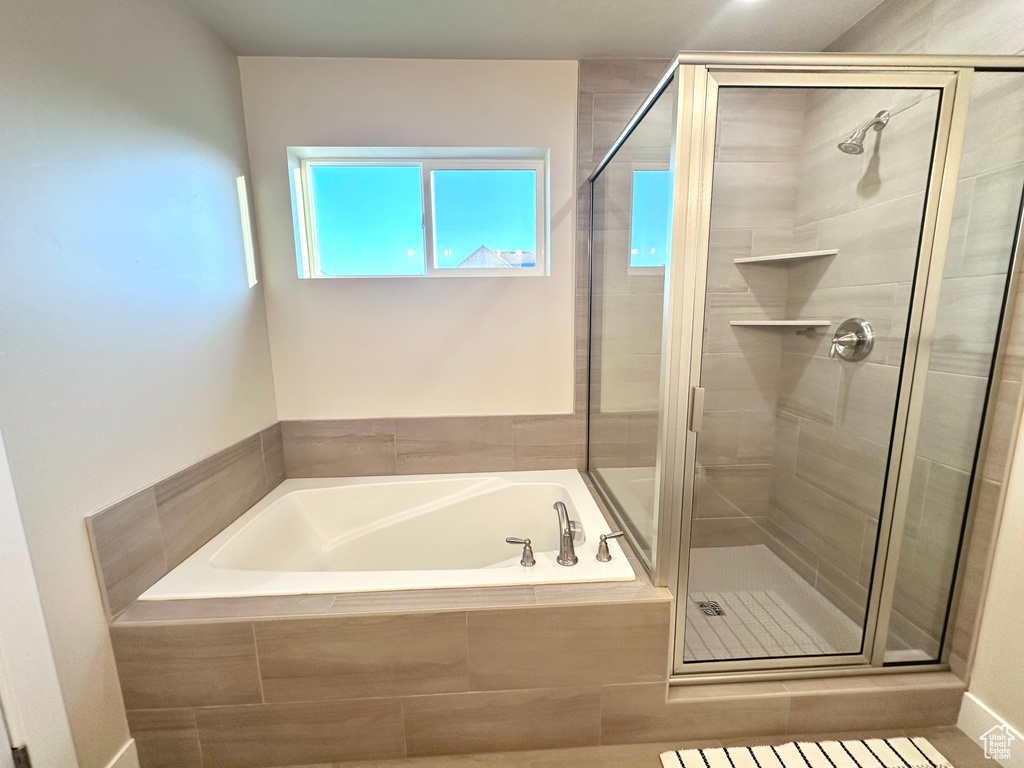 Bathroom with a bath and a stall shower