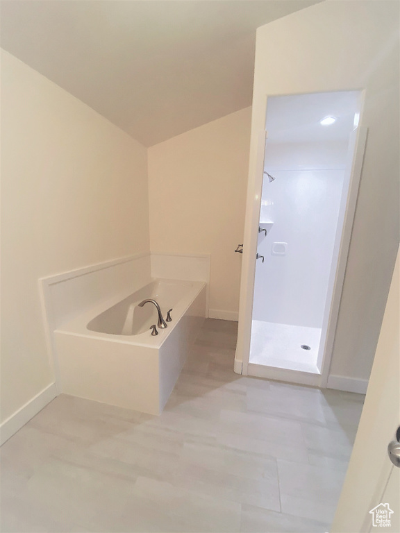 Bathroom with a shower stall and a bath