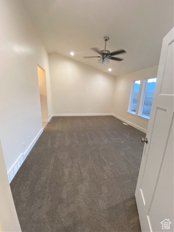 Unfurnished room with dark colored carpet, a ceiling fan, and recessed lighting