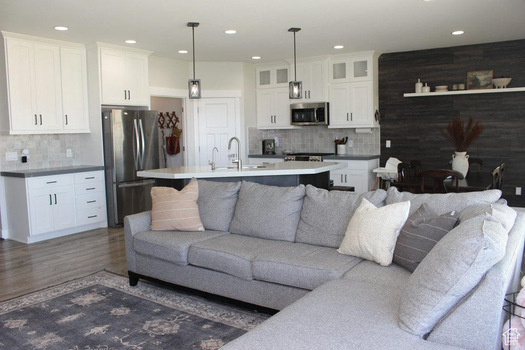Living area with wood finished floors and recessed lighting