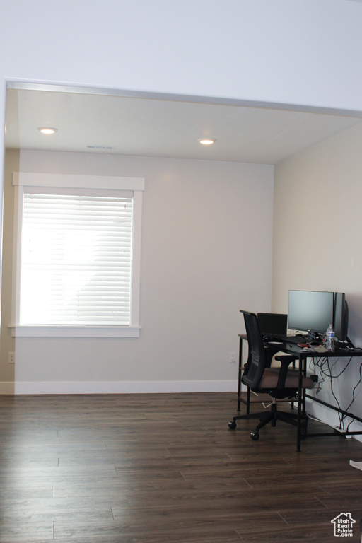 Home office with dark wood-type flooring and recessed lighting