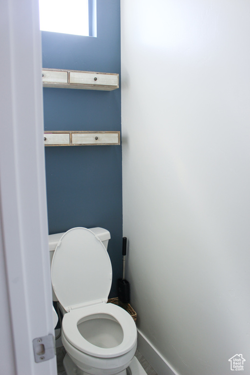 Bathroom featuring toilet and baseboards