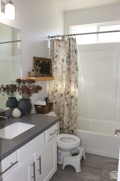 Bathroom featuring vanity and shower / bath combination with curtain