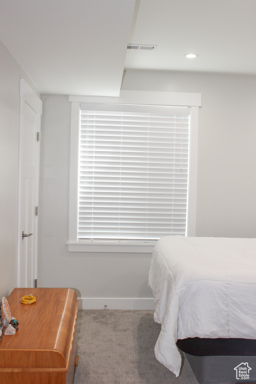 Carpeted bedroom with baseboards and recessed lighting
