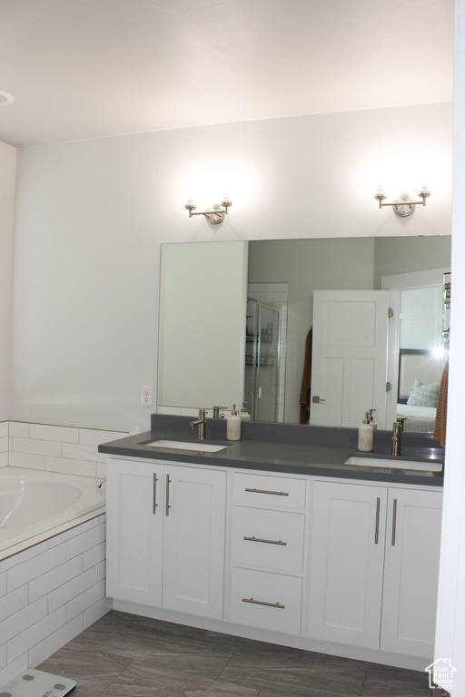 Full bath with double vanity and a garden tub