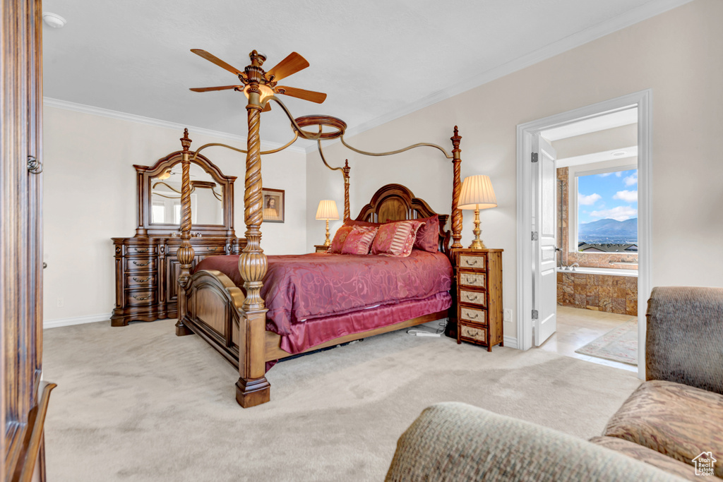 Carpeted bedroom featuring crown molding and connected bathroom