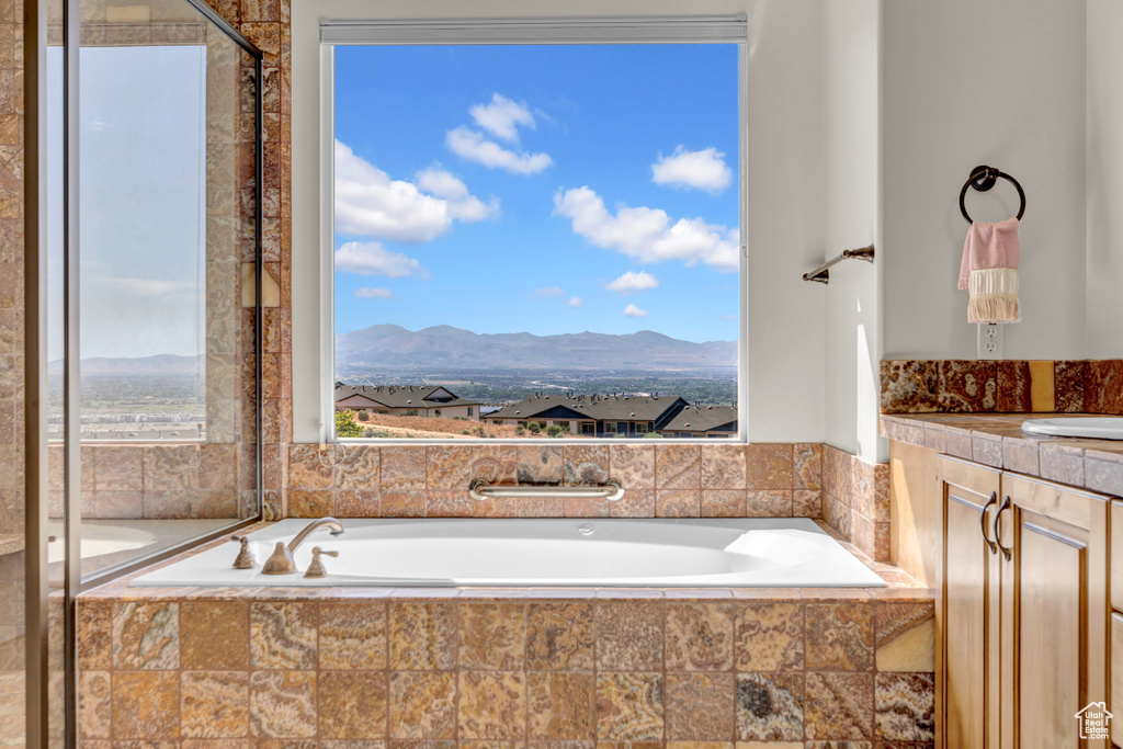 Bathroom with a bath, a mountain view, and vanity