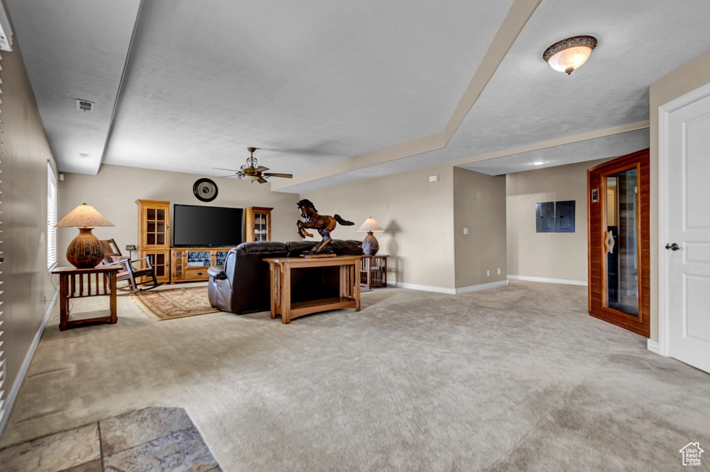Living area with carpet floors and a ceiling fan