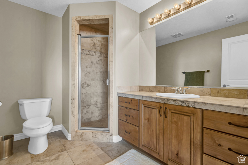 Bathroom featuring vanity and a shower stall