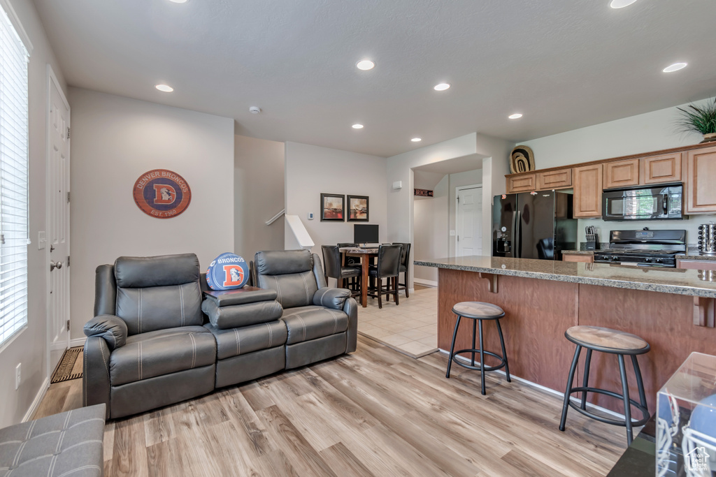 Living room featuring recessed lighting and light wood-type flooring
