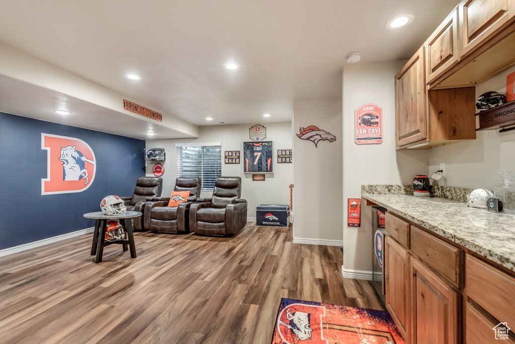 Living area featuring dark wood-type flooring and recessed lighting