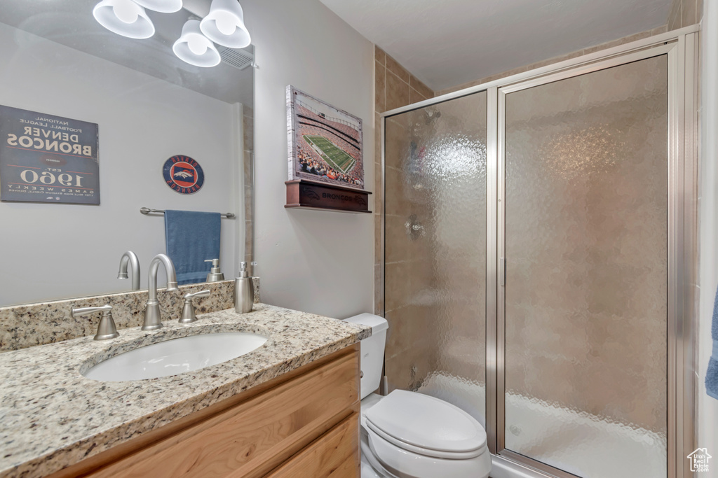 Bathroom with vanity and a stall shower