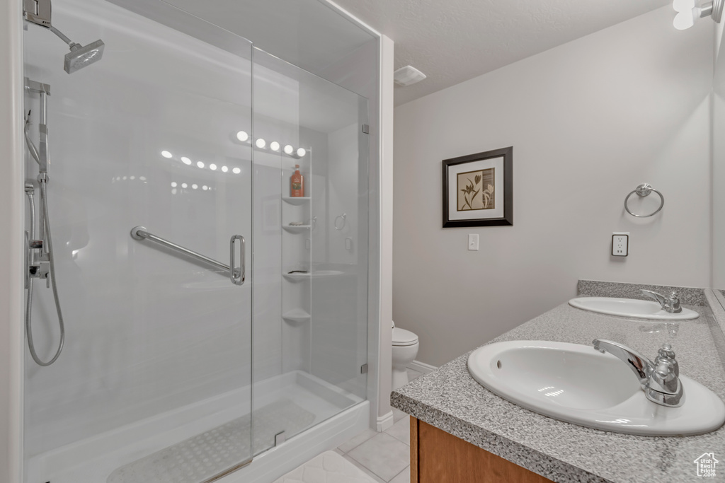 Bathroom with a stall shower and double vanity