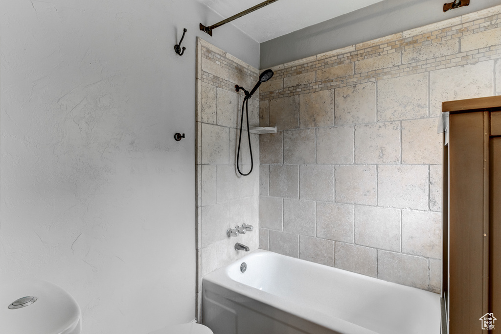 Bathroom with toilet and shower / bathtub combination