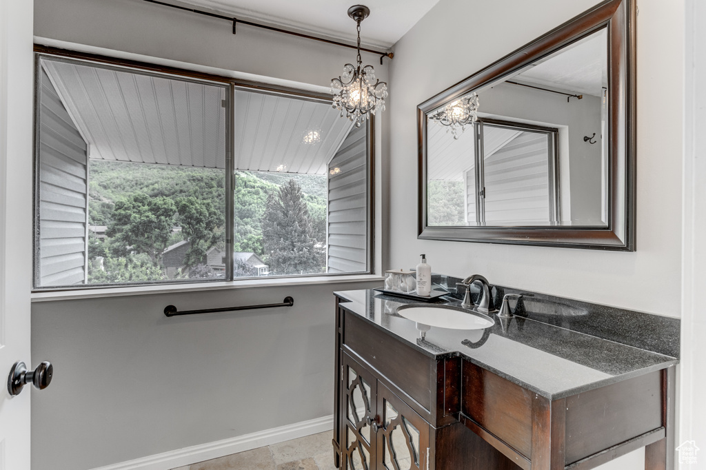 Bathroom featuring vanity and a chandelier
