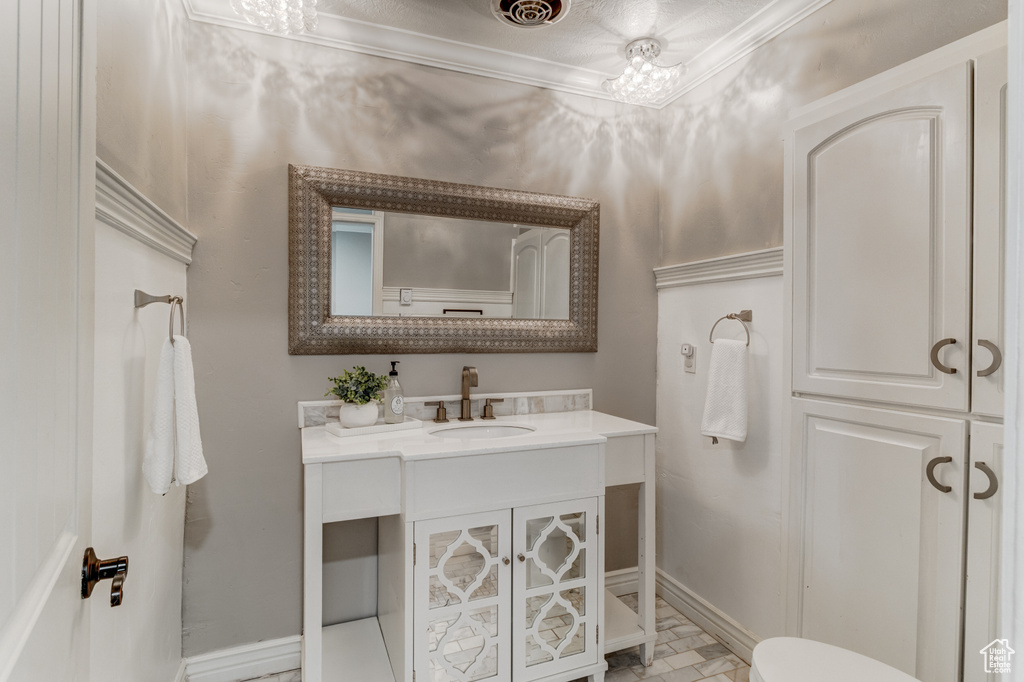 Bathroom featuring vanity and ornamental molding