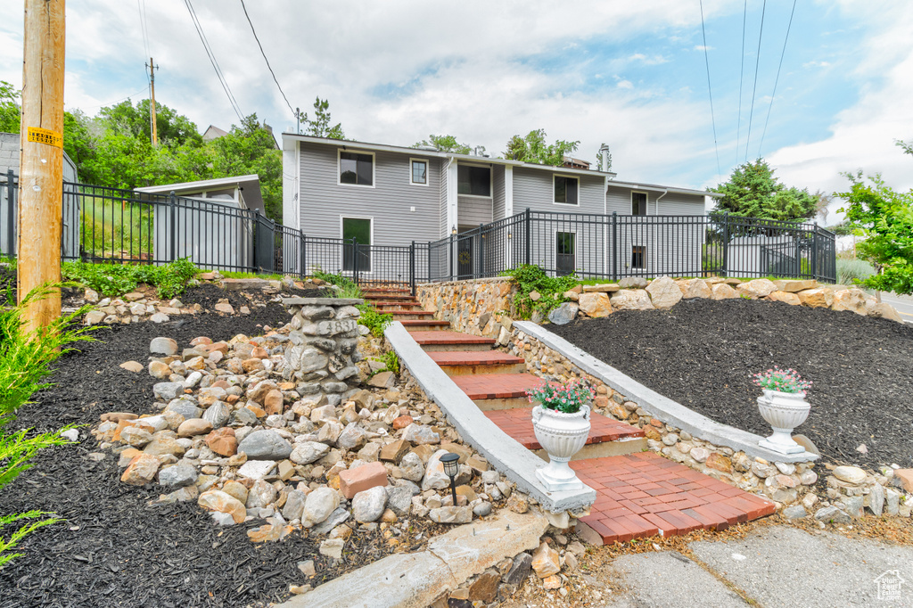 Back of property featuring stairway