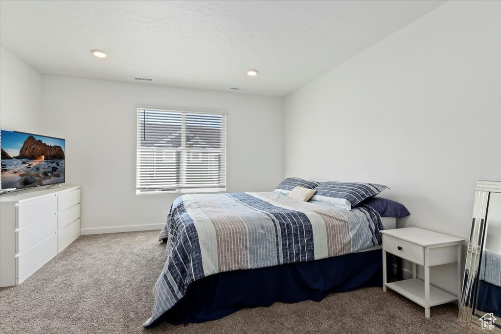 Bedroom featuring carpet floors and baseboards
