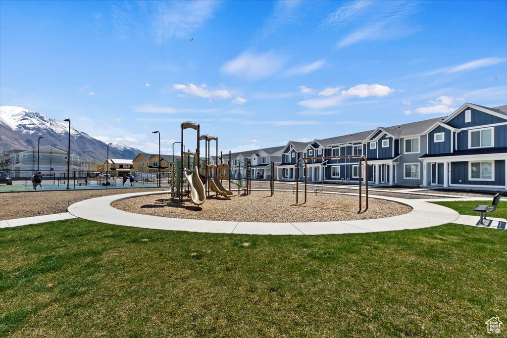 Community play area featuring a residential view, a yard, and a mountain view
