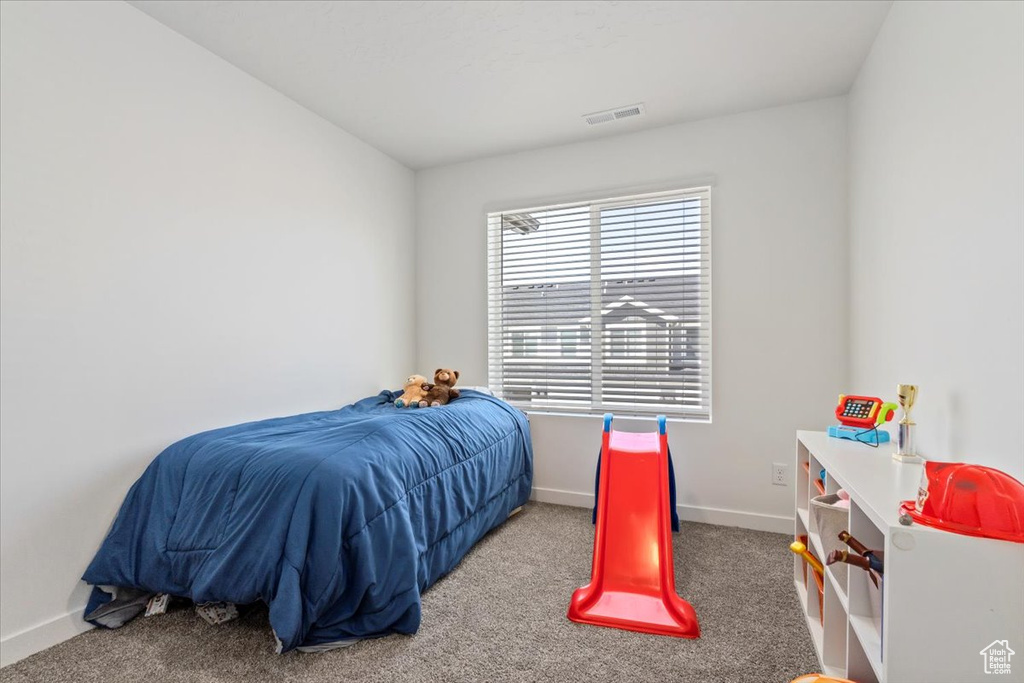 Bedroom featuring carpet flooring and baseboards