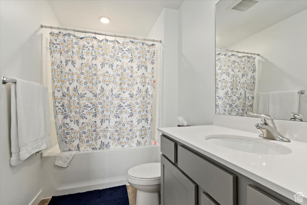 Bathroom featuring vanity and shower / tub combo