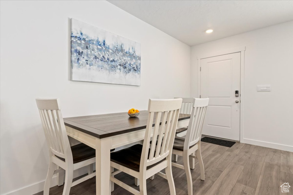 Dining space featuring light wood finished floors and recessed lighting