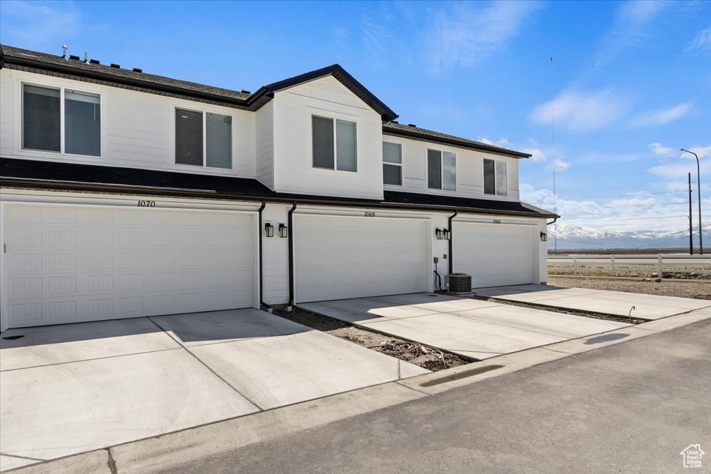 View of front facade featuring a garage and driveway