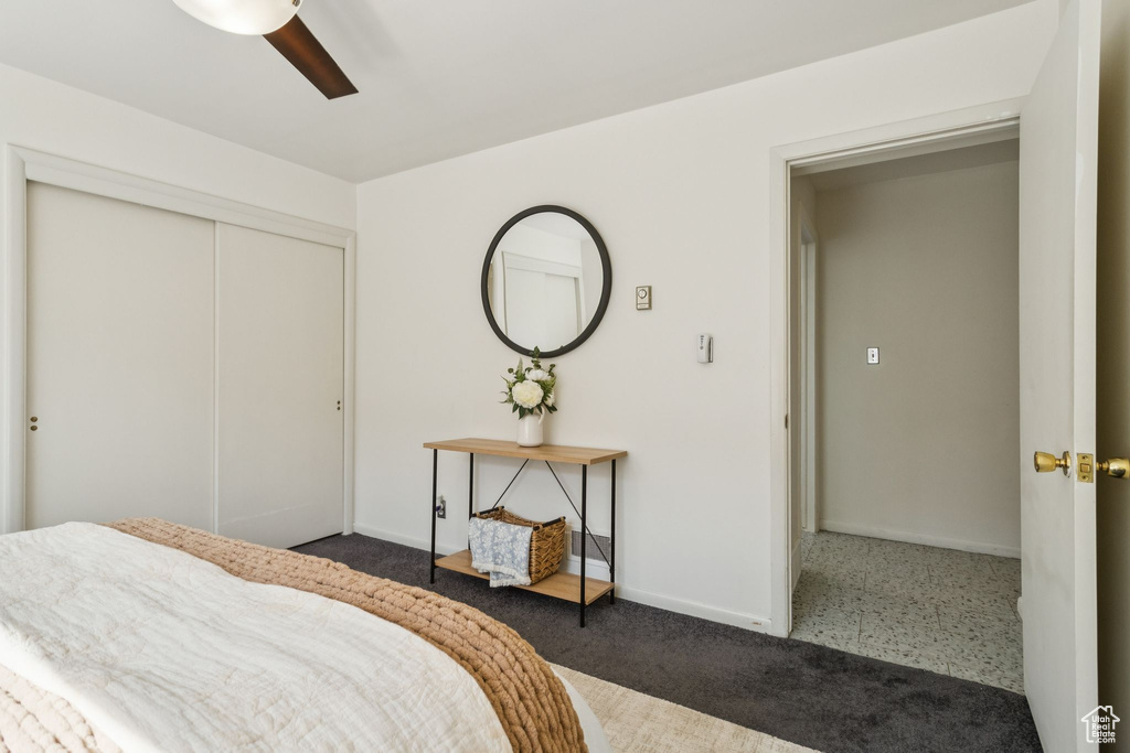 Carpeted bedroom featuring a closet and ceiling fan