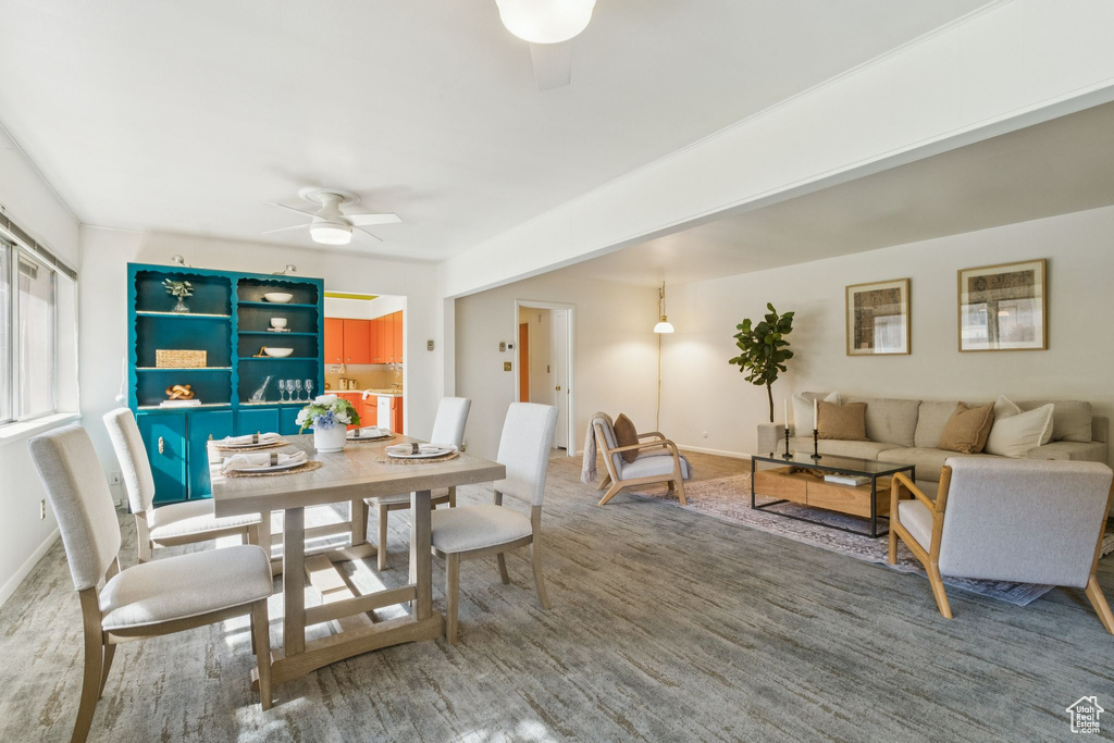 Dining space featuring a ceiling fan and baseboards