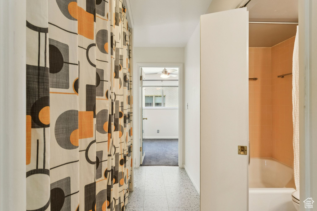 Bathroom featuring shower / tub combo and ceiling fan
