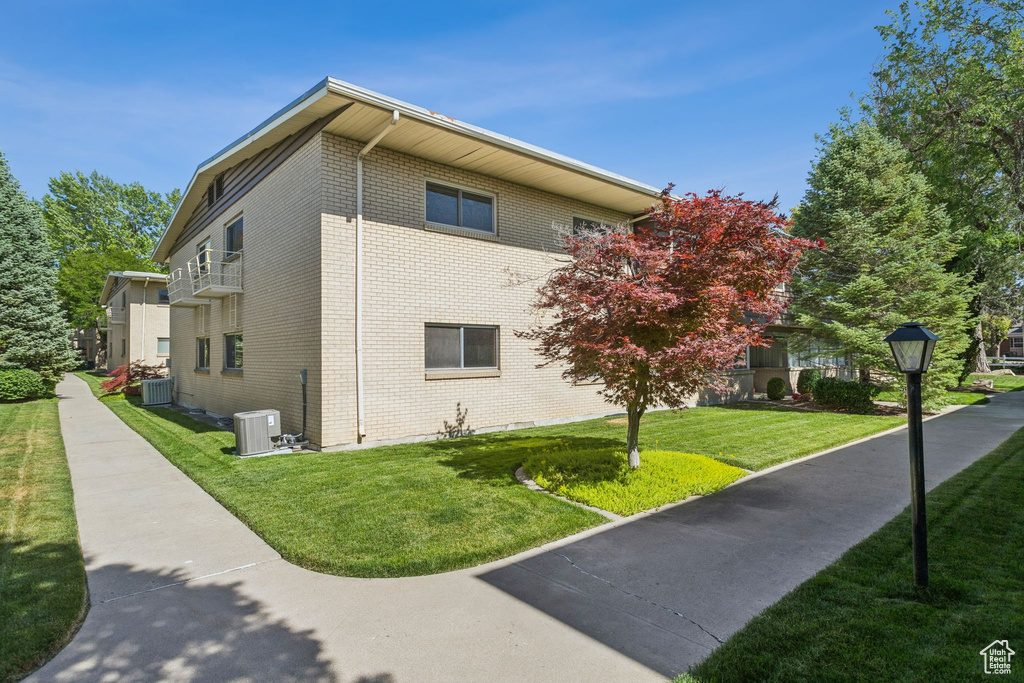 View of home\\\'s exterior with brick siding and a lawn