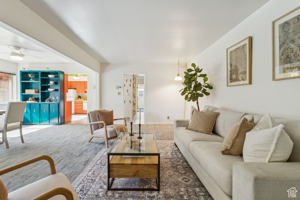Living area featuring a ceiling fan and wood finished floors