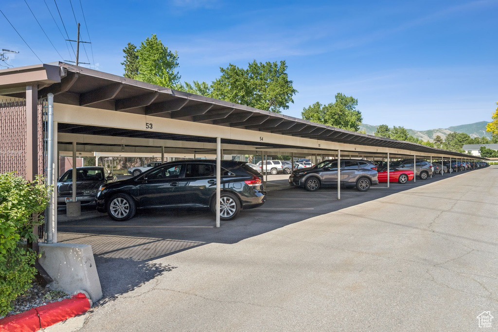 Covered parking lot featuring a mountain view