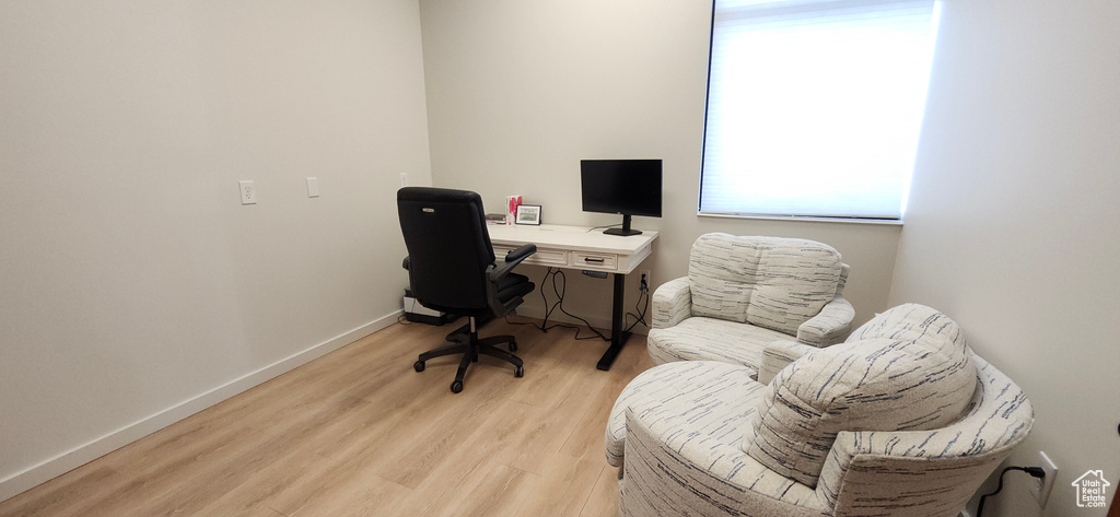 Office space featuring light wood-type flooring and baseboards