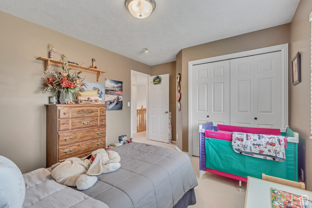Bedroom with carpet flooring and a closet