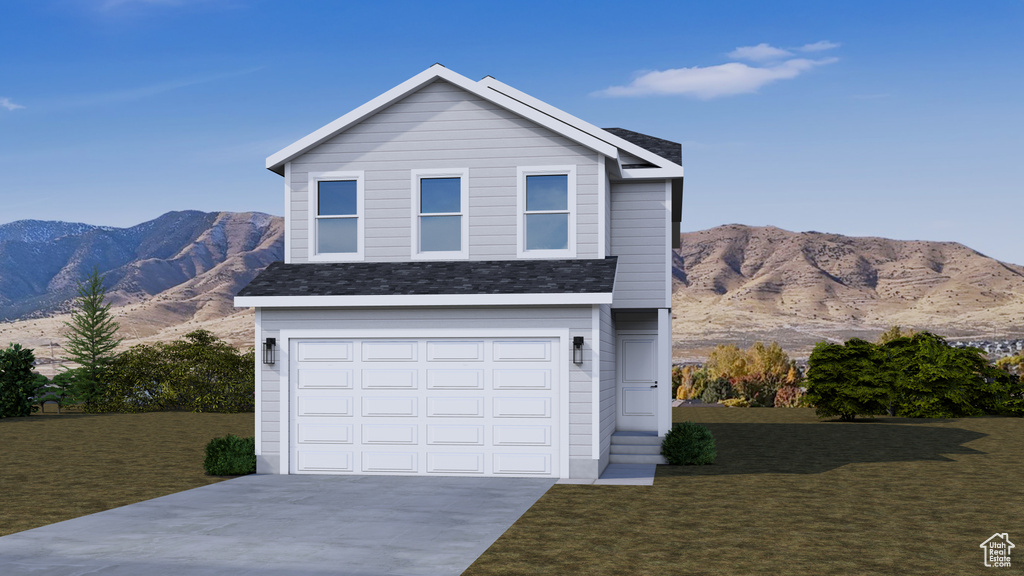 Traditional-style house featuring a mountain view, driveway, and a front lawn