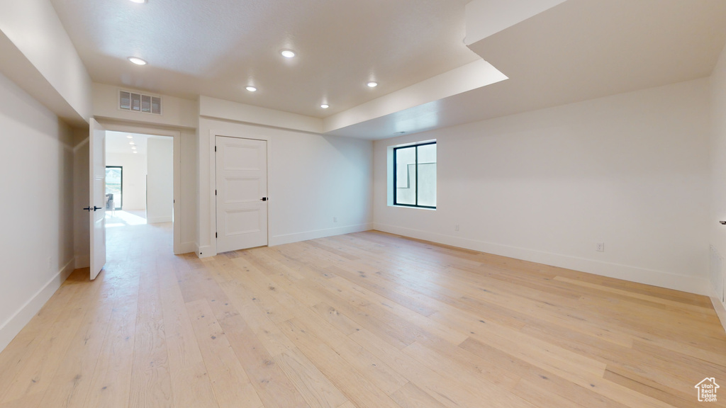 Empty room featuring light wood-style flooring and recessed lighting