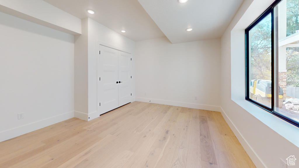 Empty room featuring light wood-style floors and recessed lighting