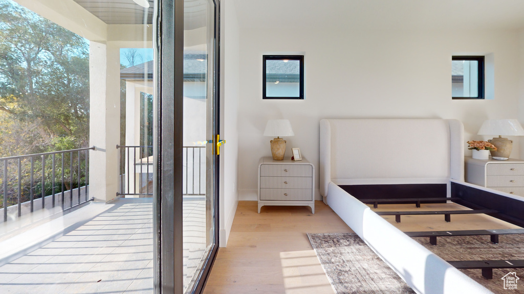 Bedroom with wood finished floors and access to exterior