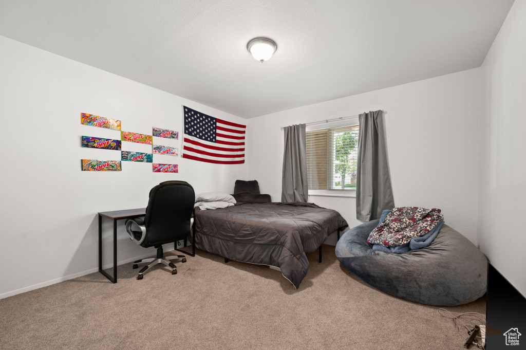 Bedroom with carpet and an office area