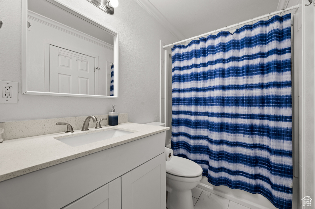 Bathroom with vanity, ornamental molding, and marble finish flooring
