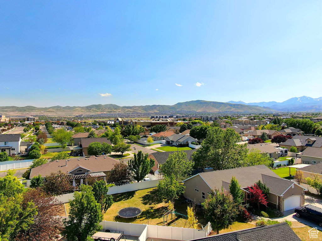Aerial view of residential area featuring a mountainous background