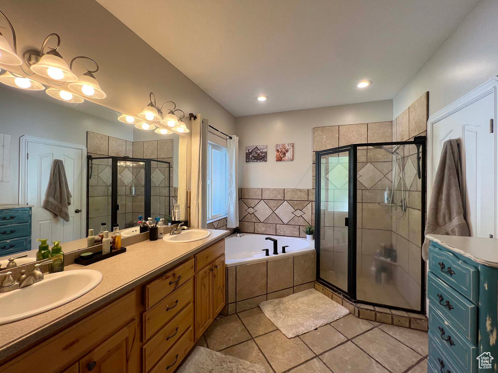 Bathroom with a stall shower, a garden tub, tile patterned floors, and double vanity
