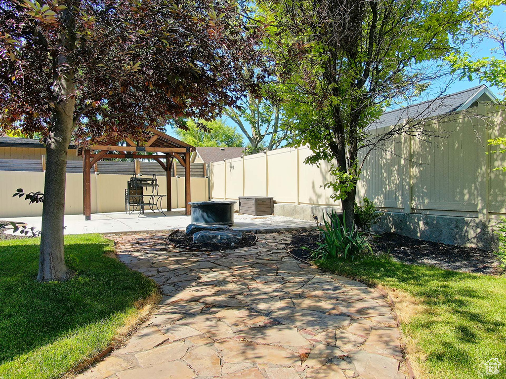 Fenced backyard with a gazebo and a patio