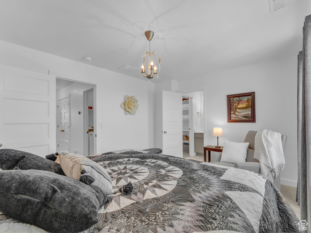 Bedroom featuring a chandelier and light colored carpet