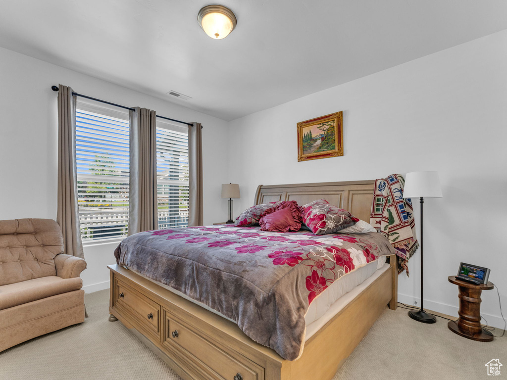 Bedroom with light carpet